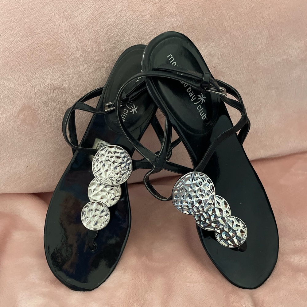 Black sandal with silver decor between the toe